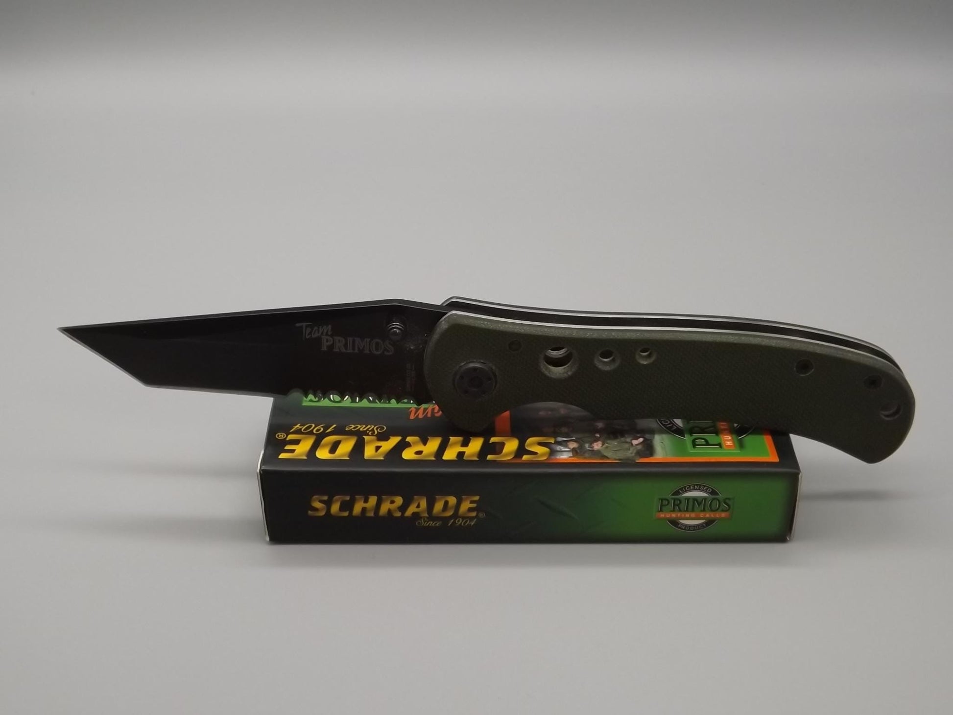 Schrade "Team Primo's" liner lock folding Tanto blade Knife. With original box and paperwork.