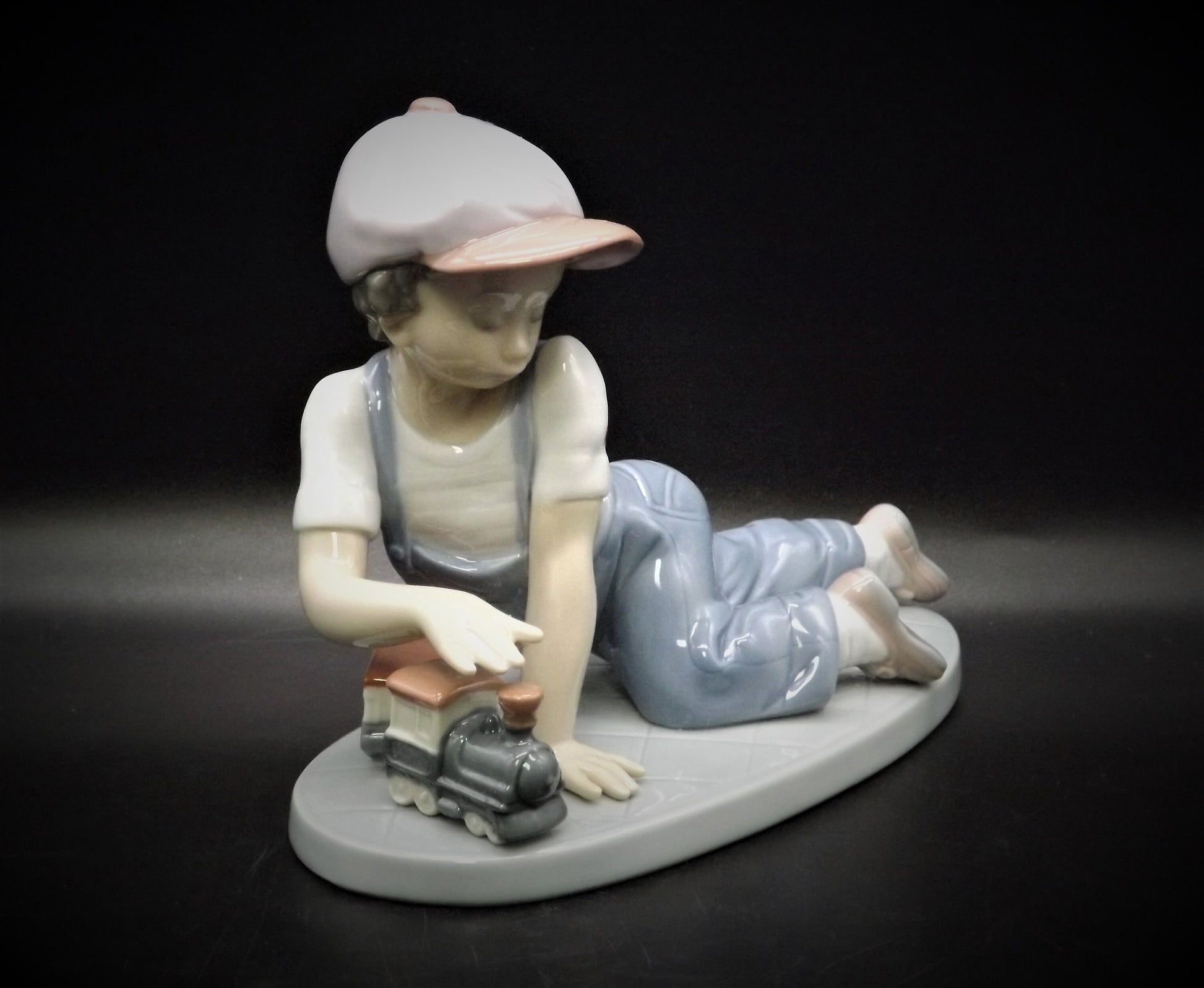 Vintage Lladro "All Aboard" #7619 with original box. Young Boy playing with his trains. Completely intact! Excellent condition!