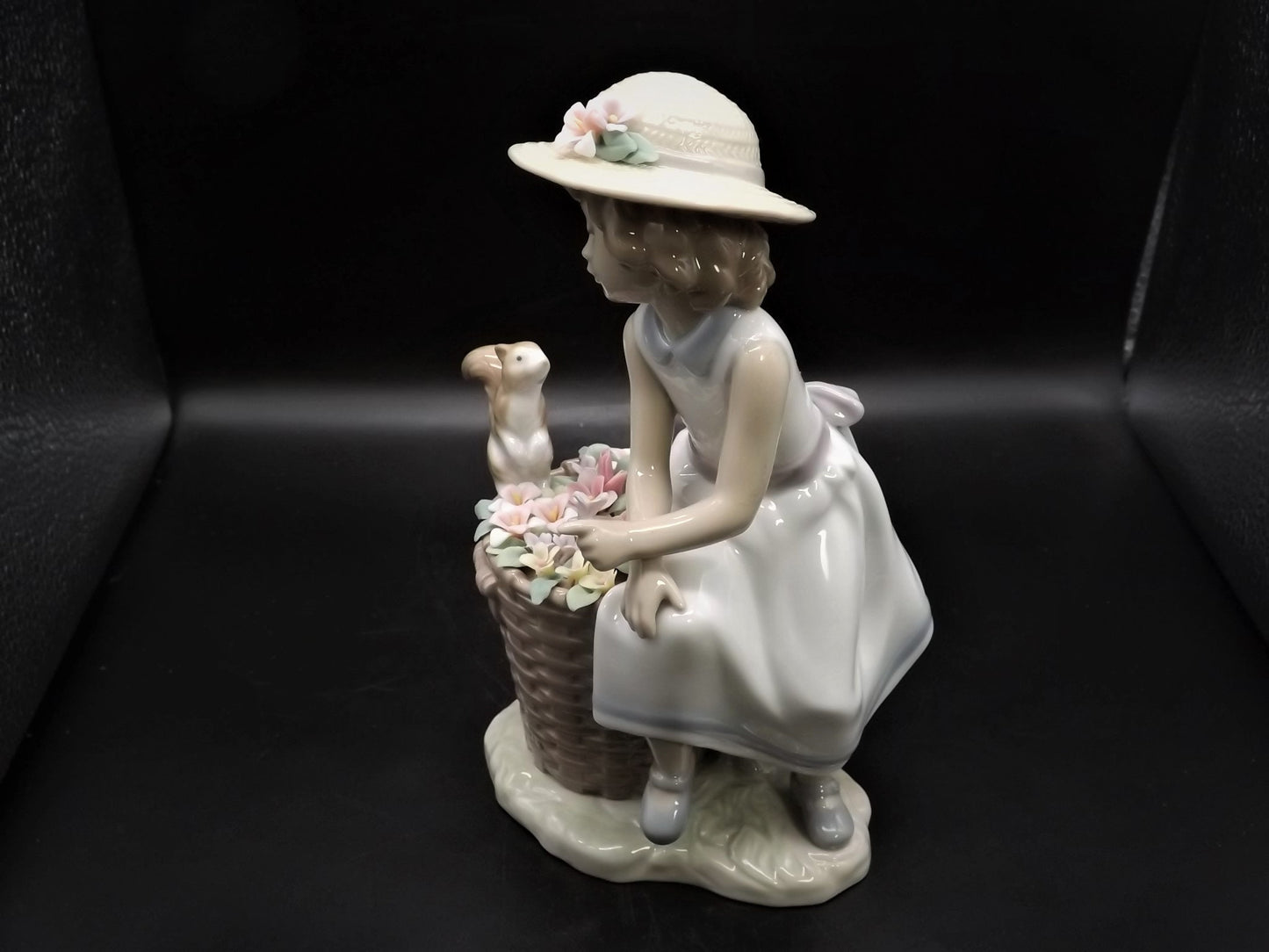 Vintage Lladro "Hello Little Squirrel" #6825 with original box. Girl and squirrel with flowers. 2 petals missing as shown in photos.