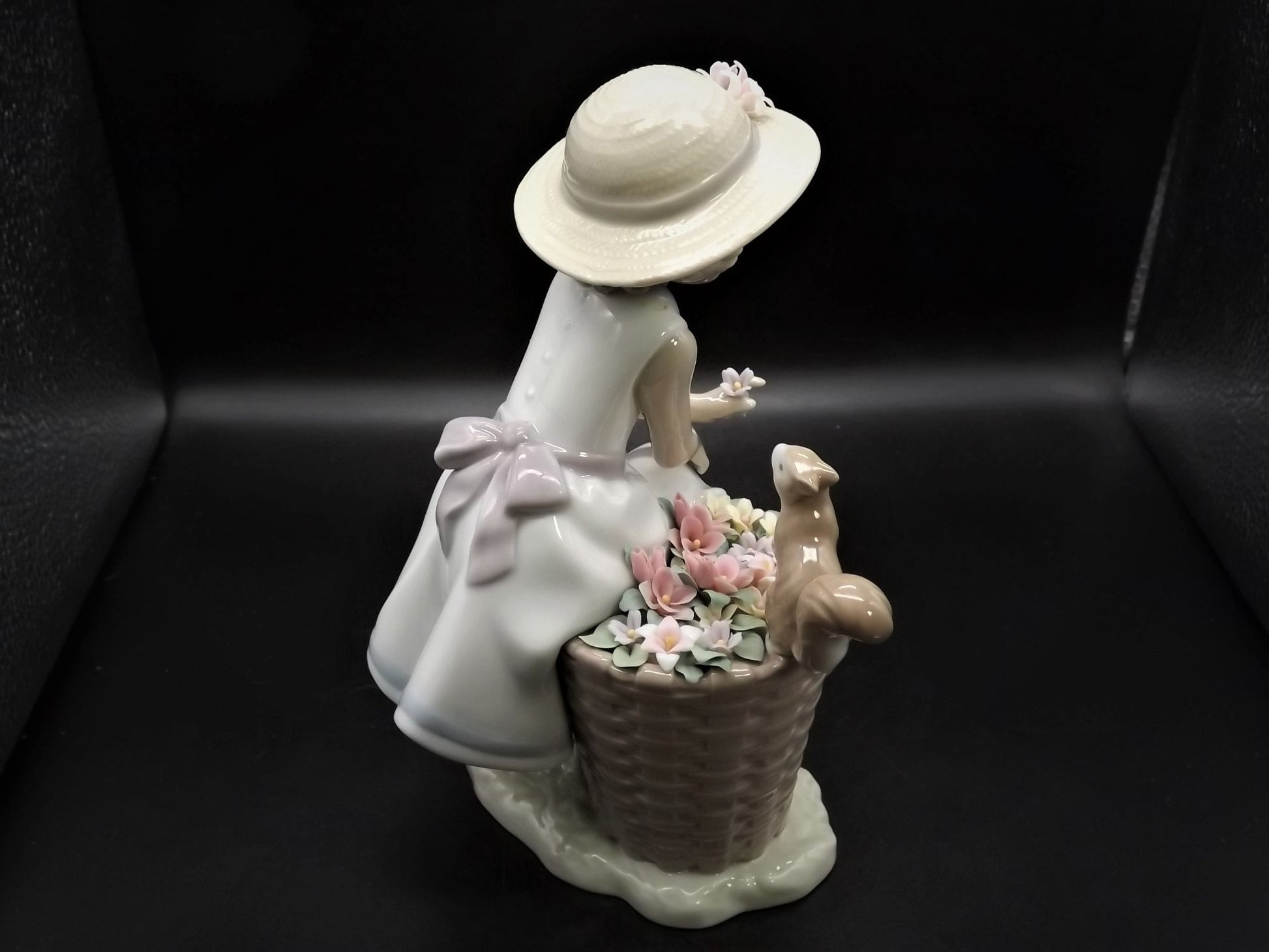 Vintage Lladro "Hello Little Squirrel" #6825 with original box. Girl and squirrel with flowers. 2 petals missing as shown in photos.