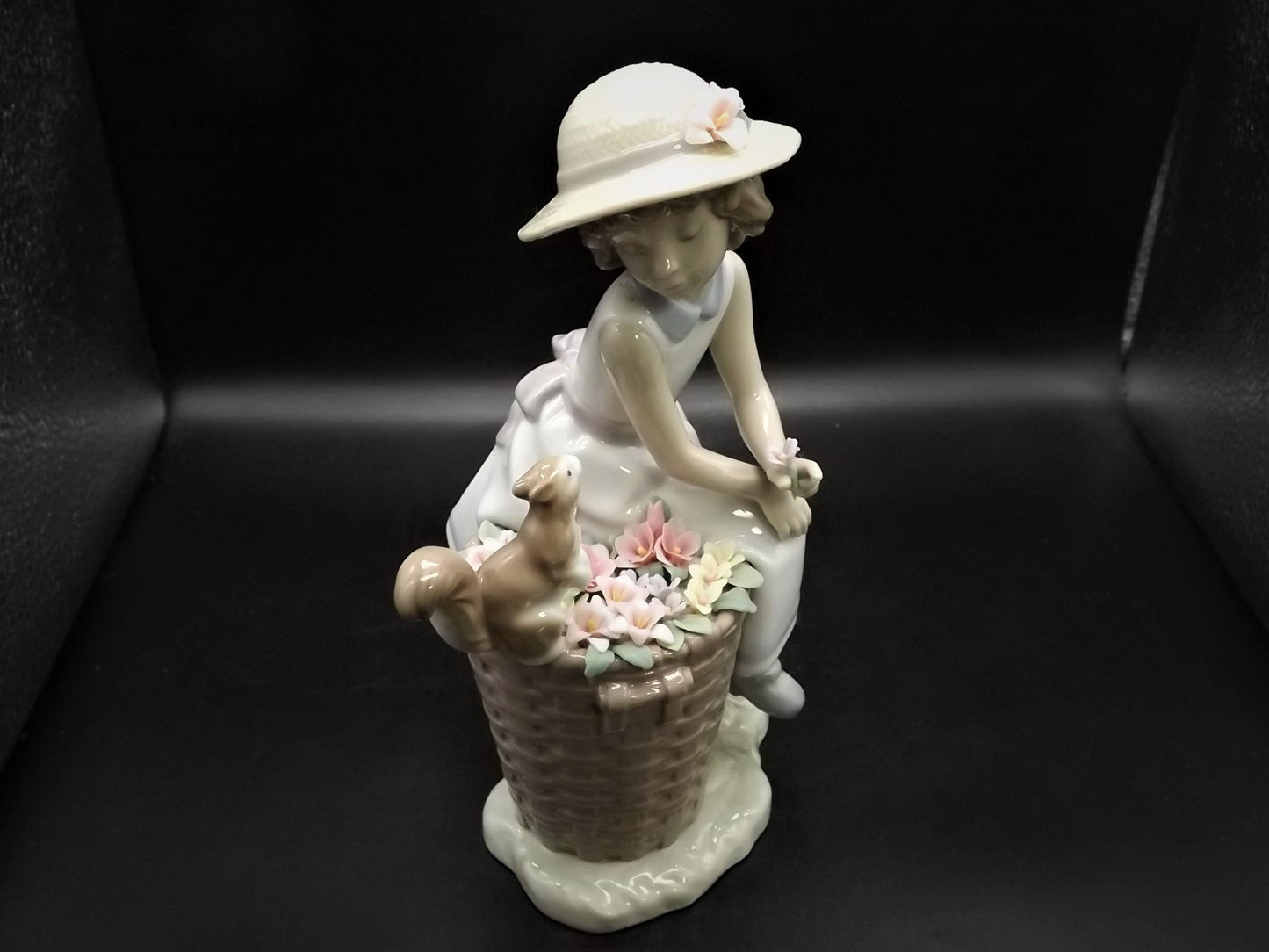 Vintage Lladro "Hello Little Squirrel" #6825 with original box. Girl and squirrel with flowers. 2 petals missing as shown in photos.