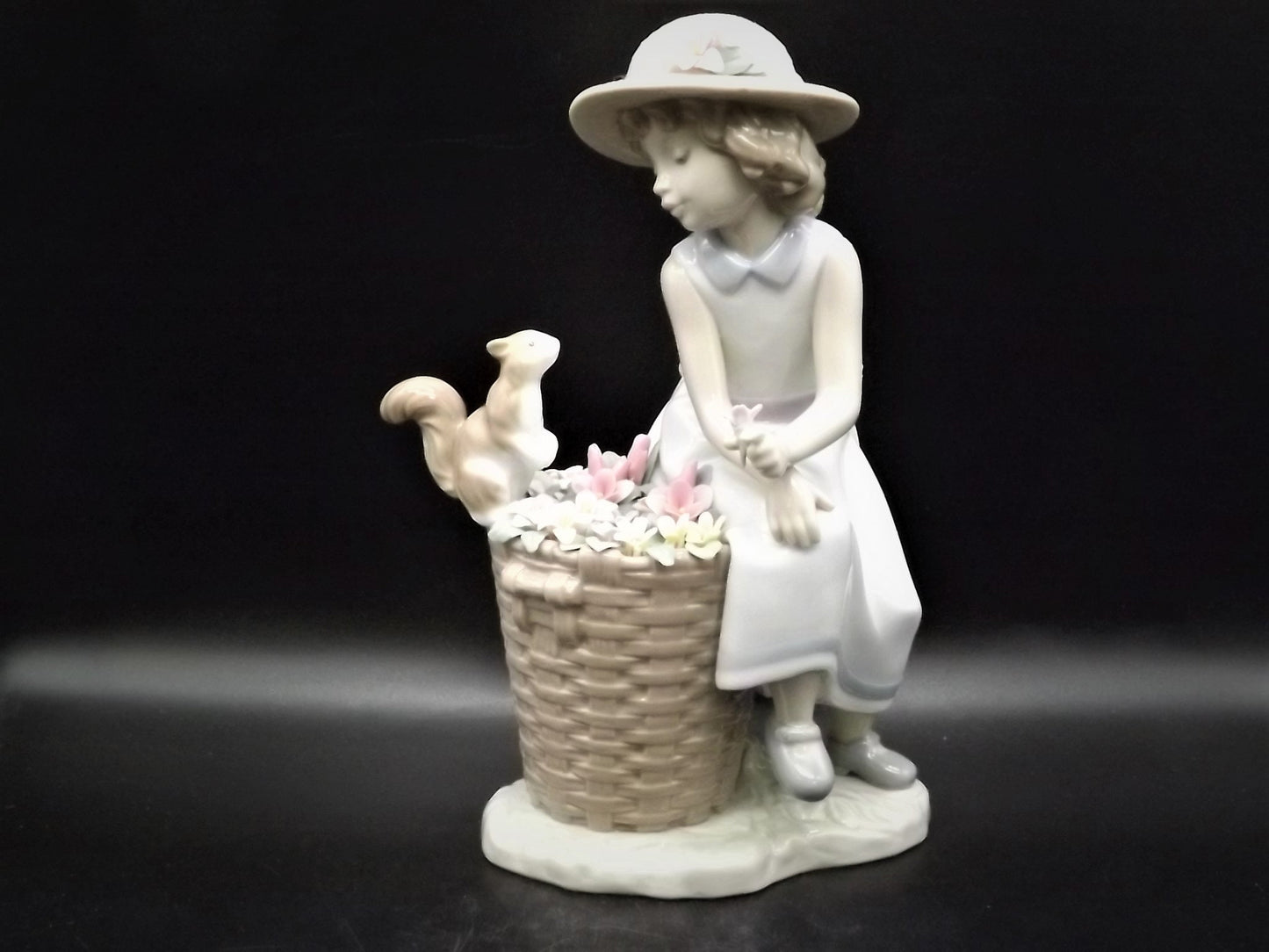 Vintage Lladro "Hello Little Squirrel" #6825 with original box. Girl and squirrel with flowers. 2 petals missing as shown in photos.