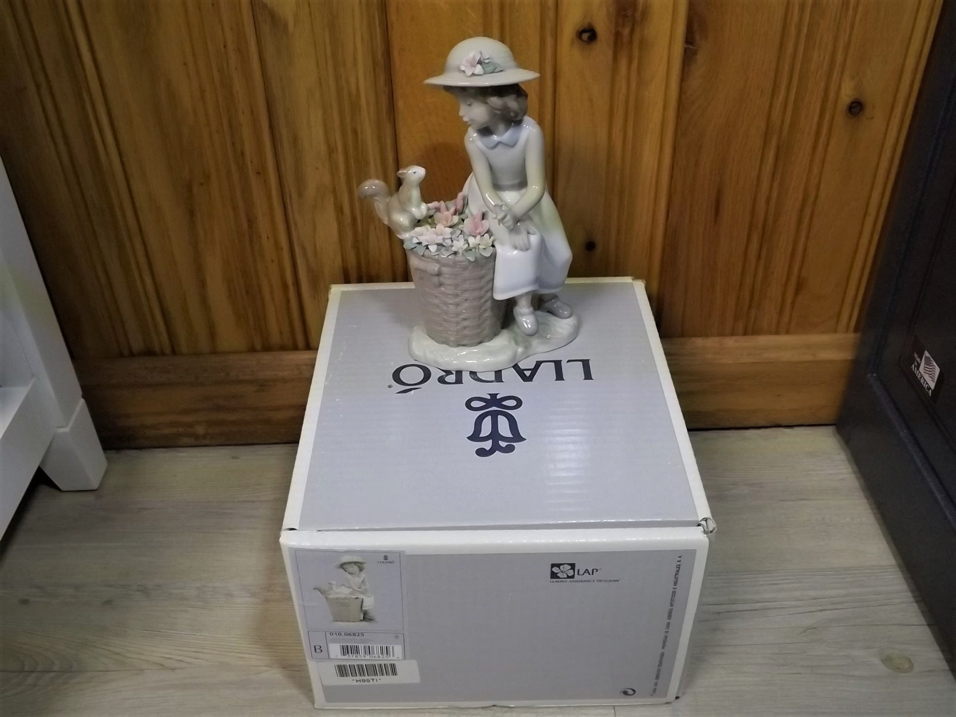 Vintage Lladro "Hello Little Squirrel" #6825 with original box. Girl and squirrel with flowers. 2 petals missing as shown in photos.