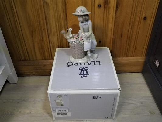 Vintage Lladro "Hello Little Squirrel" #6825 with original box. Girl and squirrel with flowers. 2 petals missing as shown in photos.