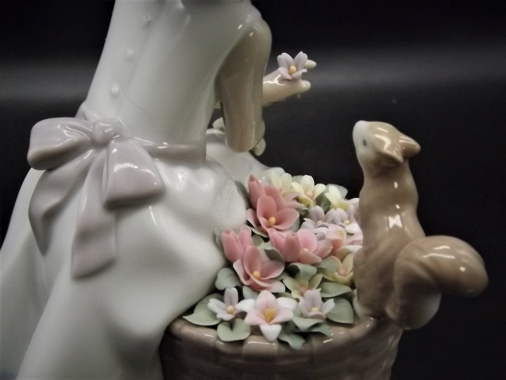 Vintage Lladro "Hello Little Squirrel" #6825 with original box. Girl and squirrel with flowers. 2 petals missing as shown in photos.