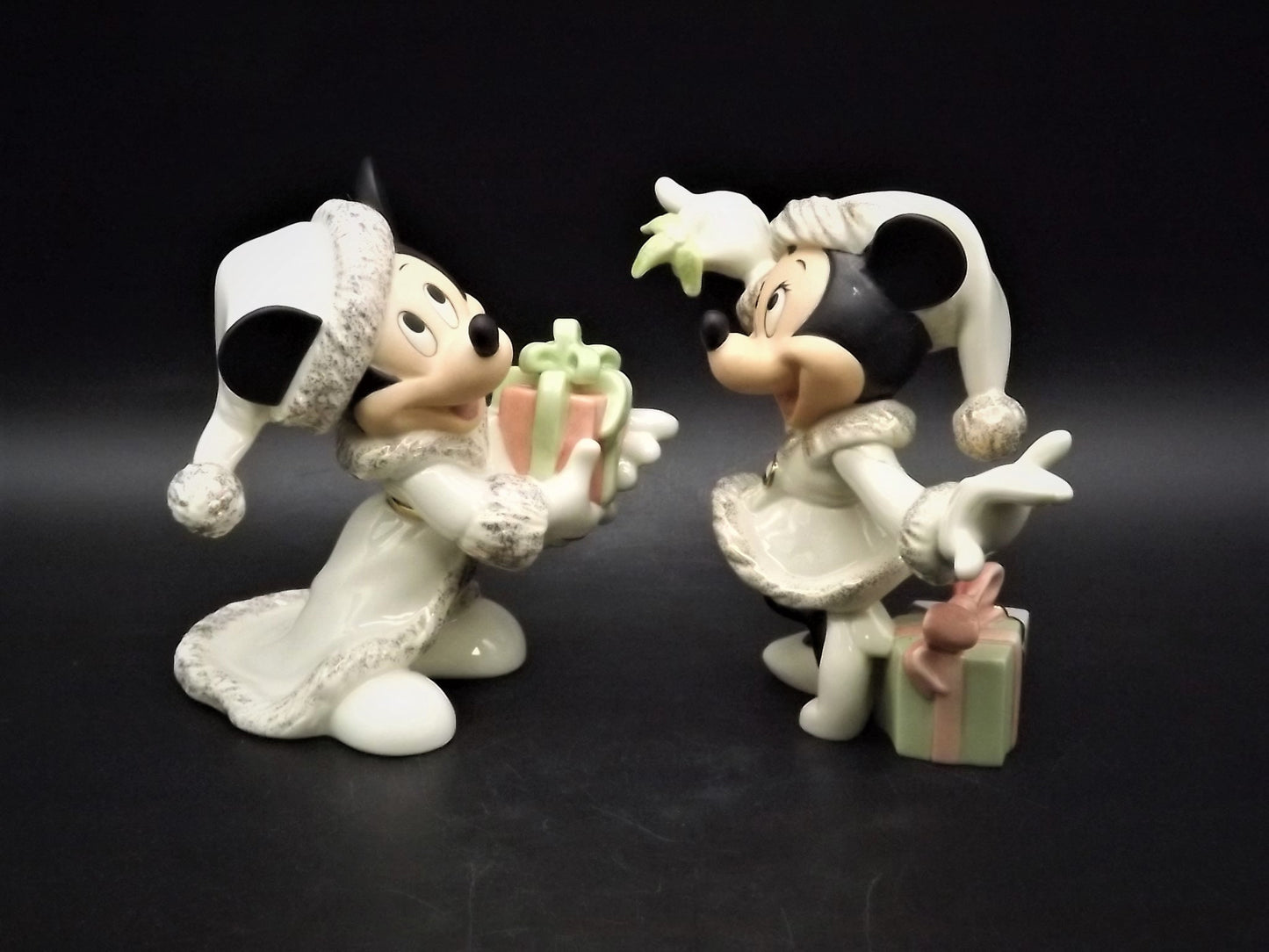 Lenox Christmas with Mickey and Minnie's Christmas Wish Porcelain Figurines. Minnie is holding Mistletoe and Mickey with a present. Great!