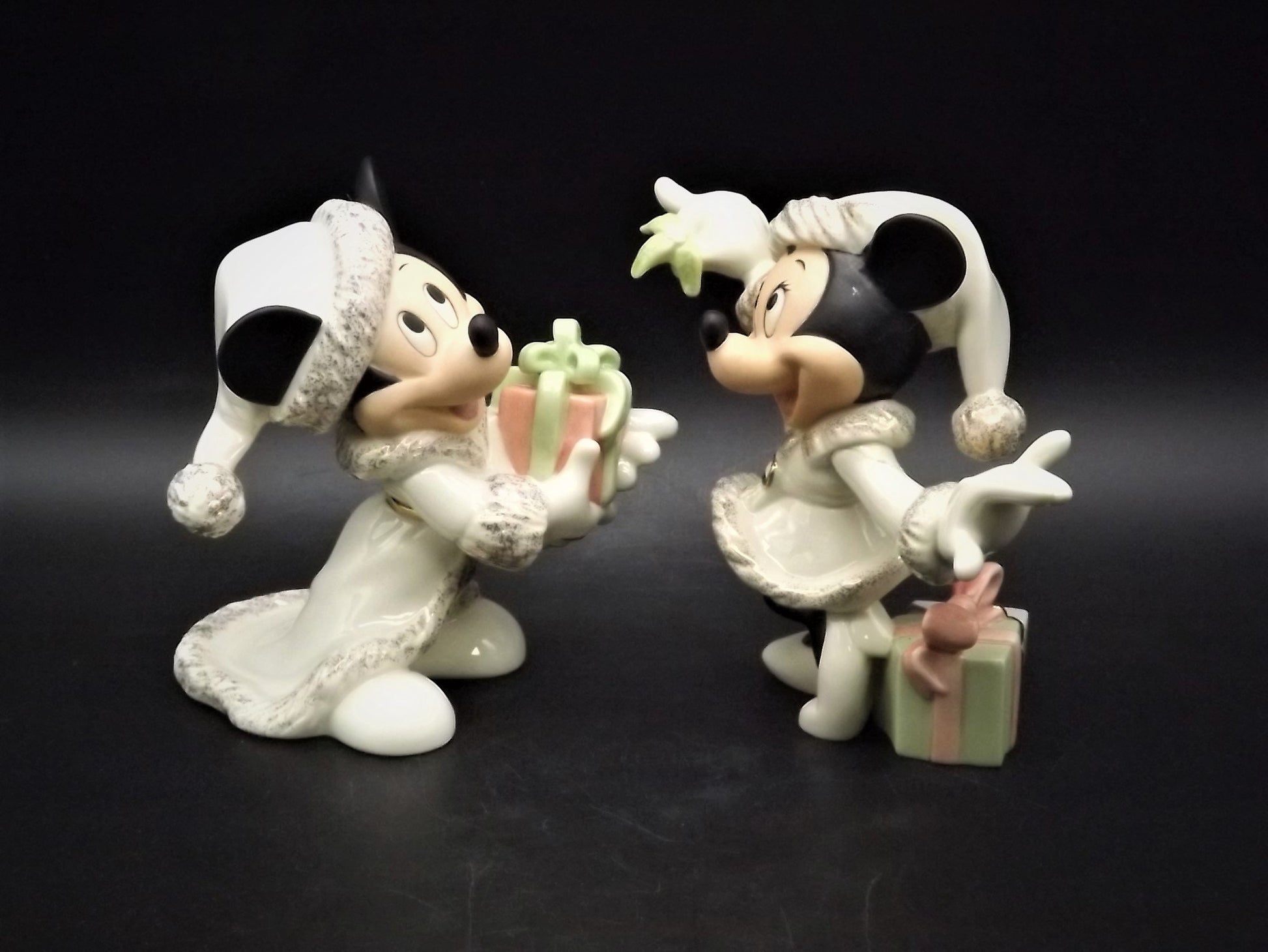 Lenox Christmas with Mickey and Minnie's Christmas Wish Porcelain Figurines. Minnie is holding Mistletoe and Mickey with a present. Great!