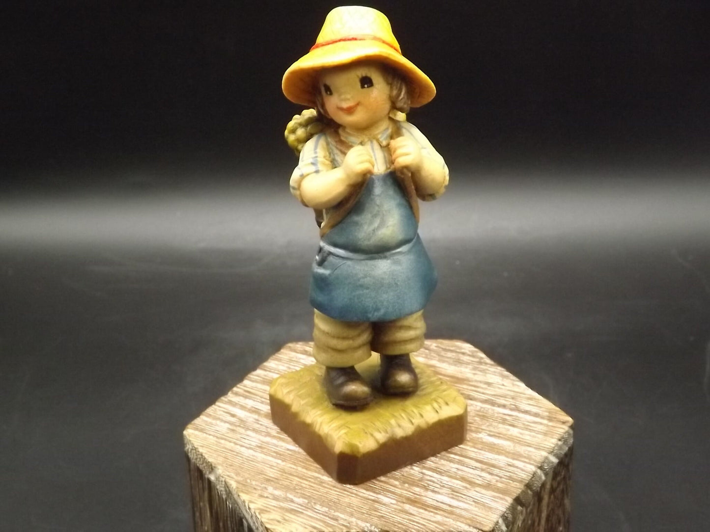 Vintage Anri "Harvest Time" Dark Blue carved wood figurine. Designed by Juan Ferrandiz. Young boy carrying a basket of grapes. Number 4 Club