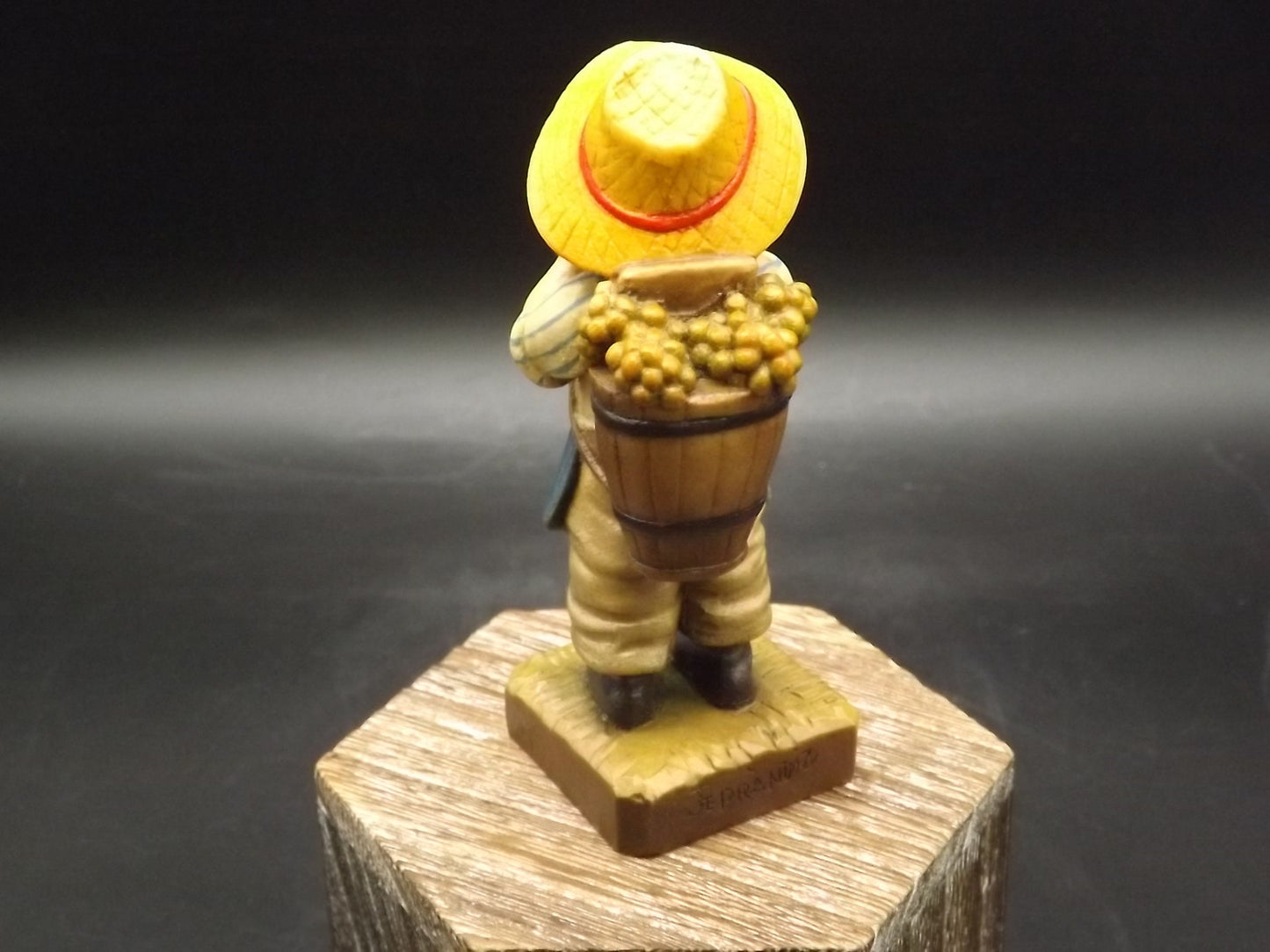 Vintage Anri "Harvest Time" Dark Blue carved wood figurine. Designed by Juan Ferrandiz. Young boy carrying a basket of grapes. Number 4 Club