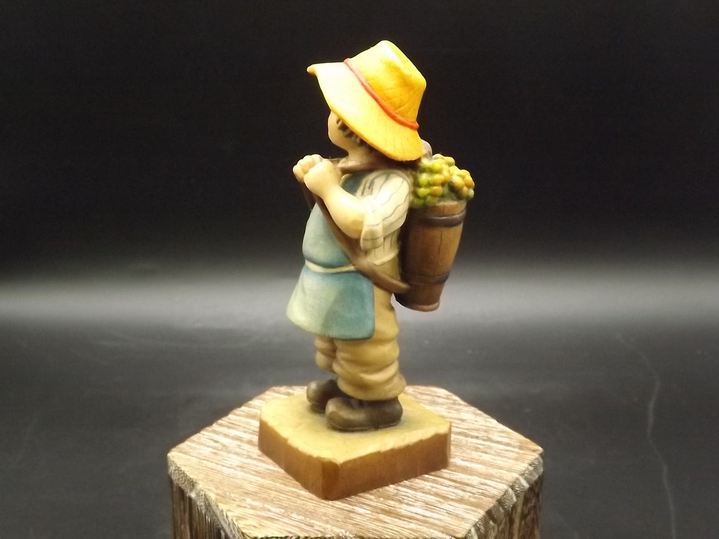 Vintage Anri "Harvest Time" Light carved wood figurine. Designed by Juan Ferrandiz. Young boy Carrying a basket of grapes. Number 4 club.