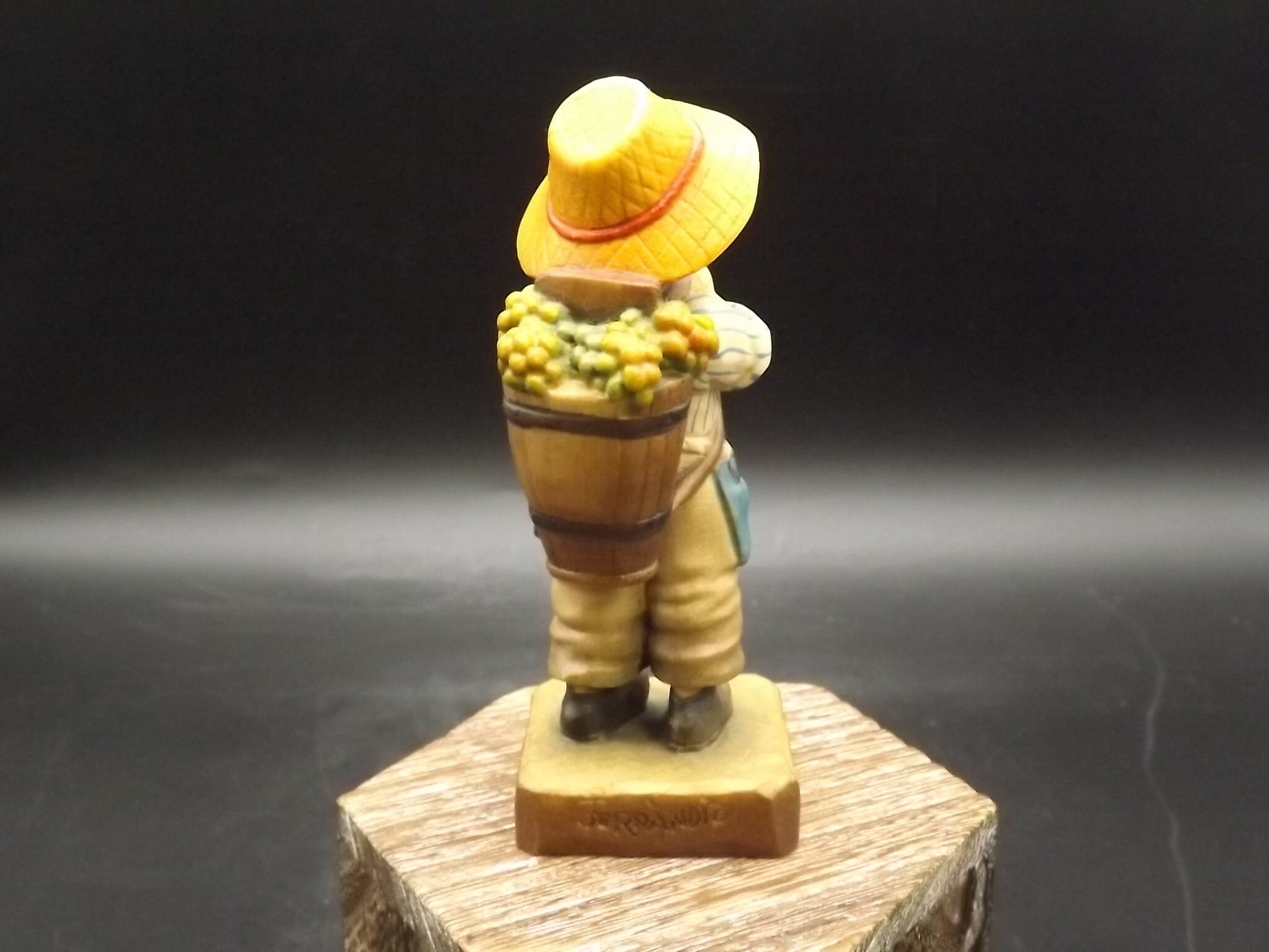 Vintage Anri "Harvest Time" Light carved wood figurine. Designed by Juan Ferrandiz. Young boy Carrying a basket of grapes. Number 4 club.