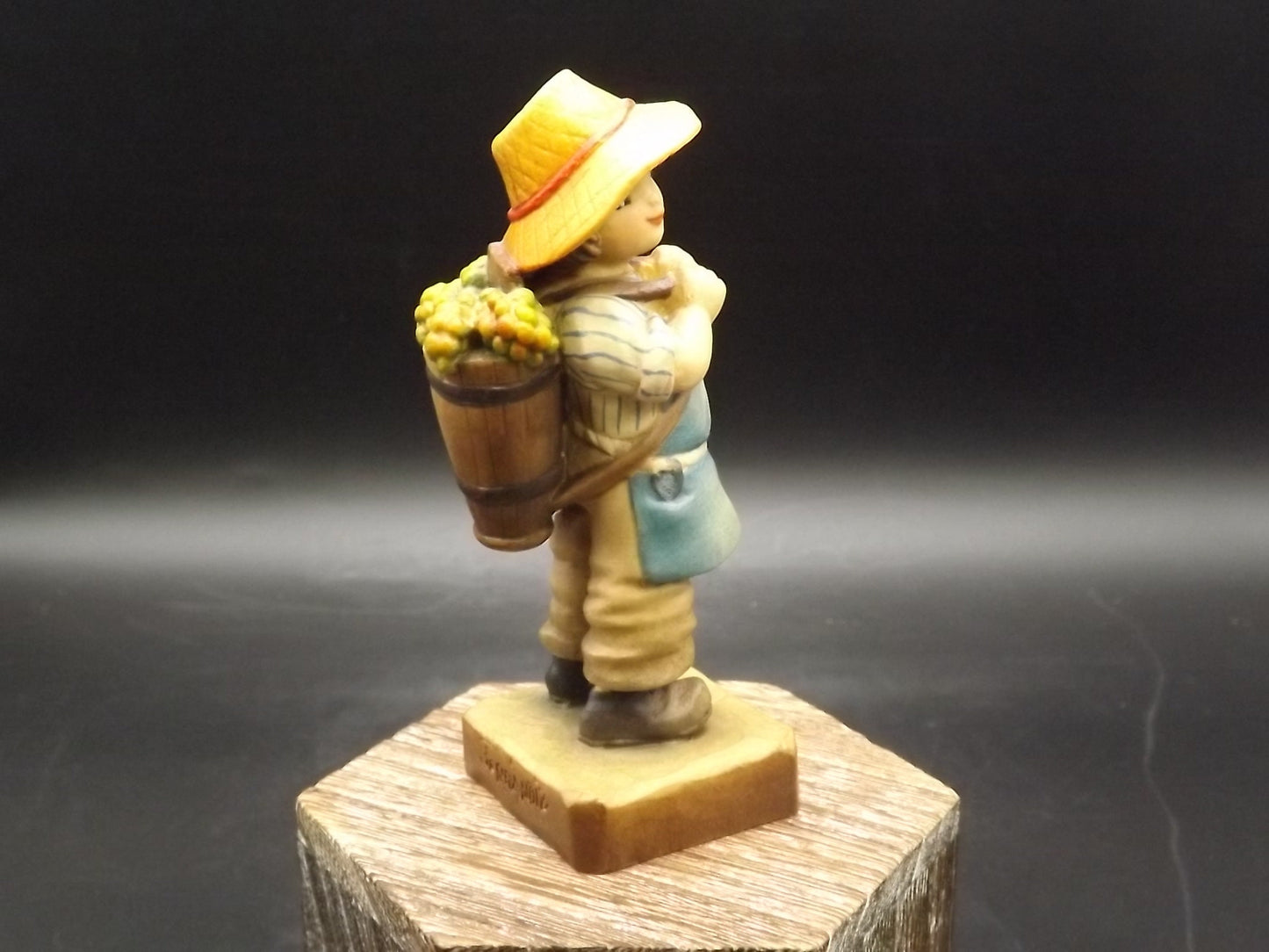 Vintage Anri "Harvest Time" Light carved wood figurine. Designed by Juan Ferrandiz. Young boy Carrying a basket of grapes. Number 4 club.