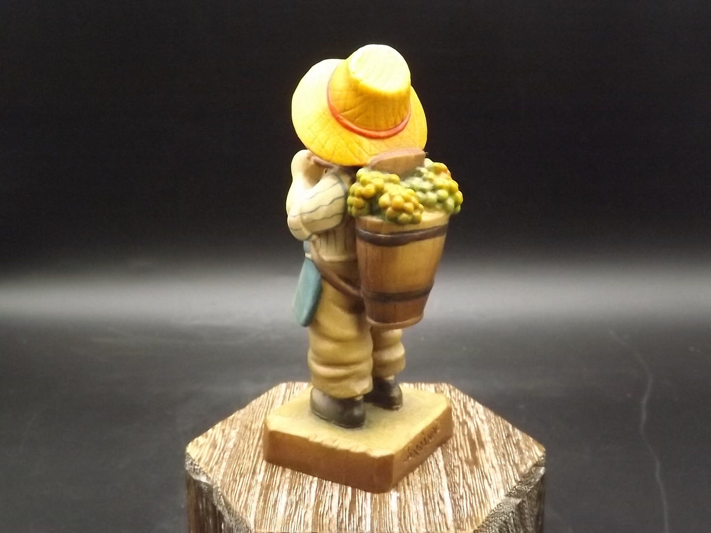 Vintage Anri "Harvest Time" Light carved wood figurine. Designed by Juan Ferrandiz. Young boy Carrying a basket of grapes. Number 4 club.
