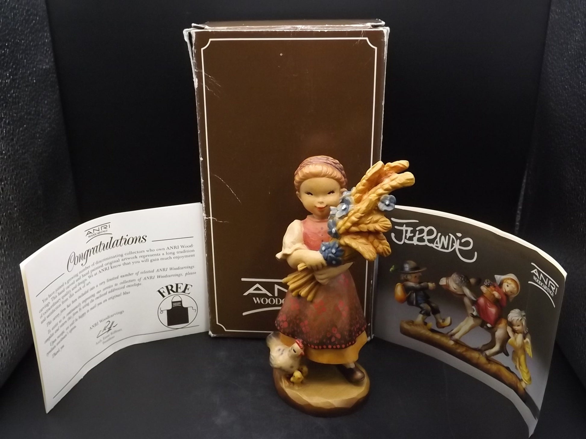Vintage Anri "Golden Sheaves" carved wood figurine. Designed by Juan Ferrandiz numbered 338/2250. Young girl holding a sheaf of grain.