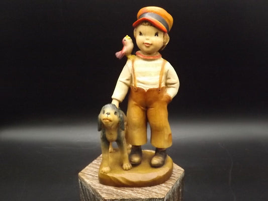 Vintage Anri "High Hopes" carved wood figurine. Designed by Juan Ferrandiz. Young boy with his pet dog and a bird perched on his shoulder.