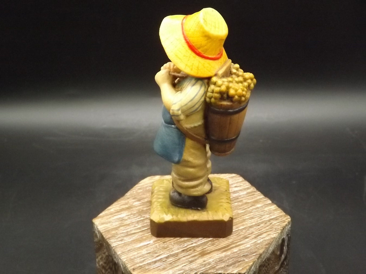 Vintage Anri "Harvest Time" Dark Blue carved wood figurine. Designed by Juan Ferrandiz. Young boy carrying a basket of grapes. Number 4 Club