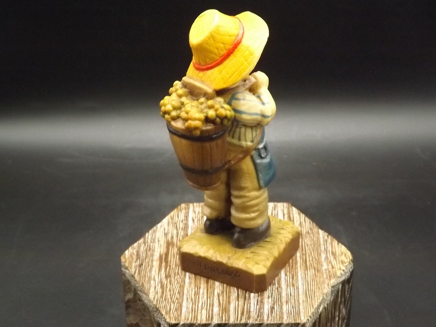 Vintage Anri "Harvest Time" Dark Blue carved wood figurine. Designed by Juan Ferrandiz. Young boy carrying a basket of grapes. Number 4 Club