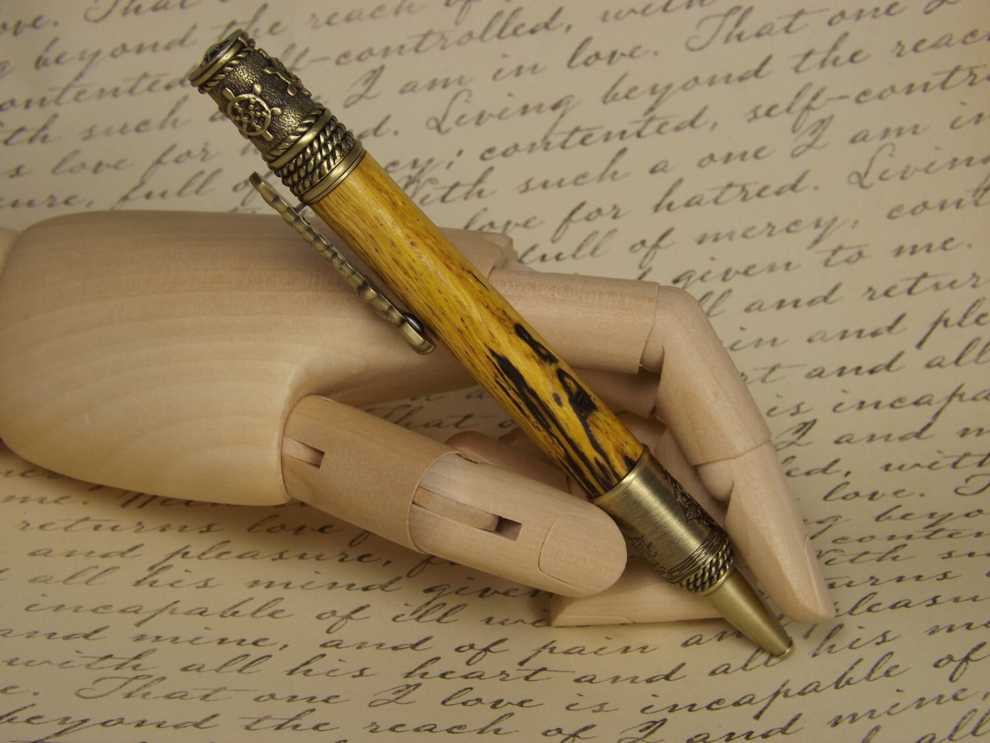 Handmade nautical pen, antique bronze with a dyed and stabilized tiger oak wood body.